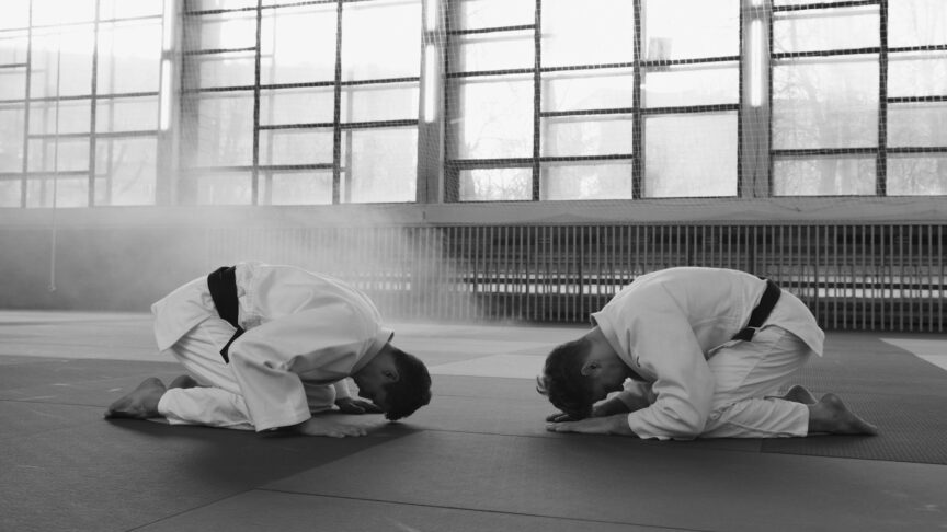 two taekwondo athletes bowing down to each other